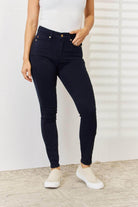 Trendsi Judy Blue tummy control skinny jeans in dark wash, designed for a flattering fit and comfort.