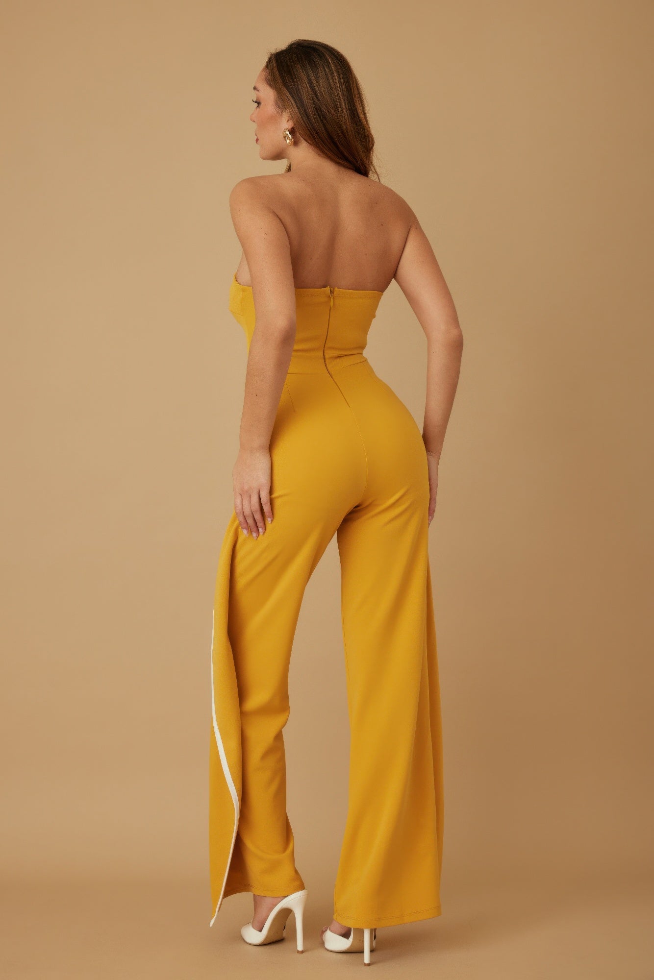 Stylish strapless jumpsuit for women in mustard yellow with a sleek side slit and fitted design