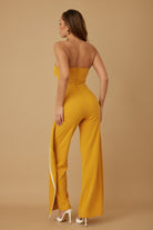Stylish strapless jumpsuit for women in mustard yellow with a sleek side slit and fitted design