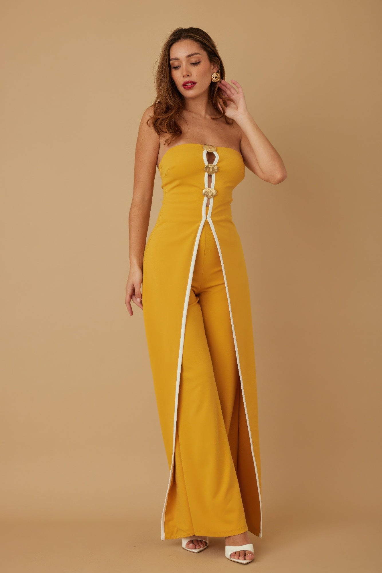Stylish strapless jumpsuit for women in yellow with a sleek design and zipper details