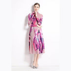 By Claude knee-length dress for travel featuring colorful floral patterns and pleated design