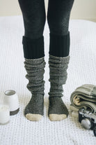 Cozy knitted lounge socks in black and gray, perfect for relaxing and warmth at home