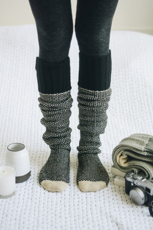 Cozy knitted lounge socks in black and gray, perfect for relaxing and warmth at home