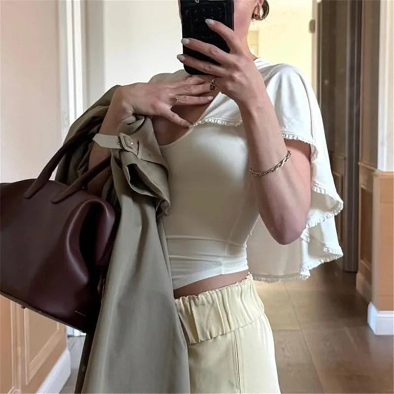 Women's beige top with lace and trim accents, perfect for casual outings