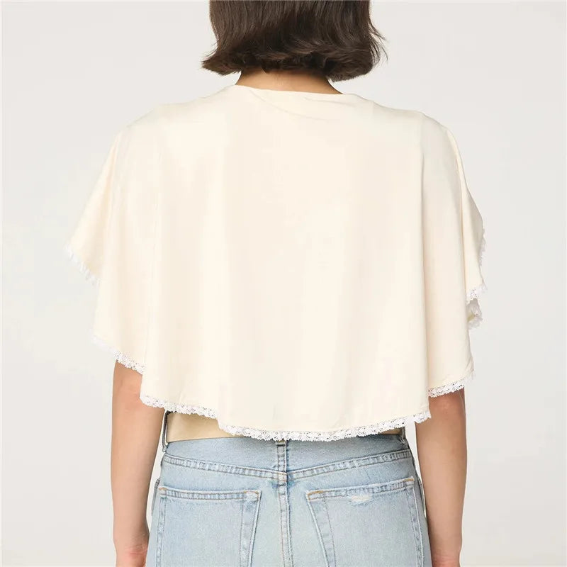 Women's lightweight ivory cape with lace and trim, perfect for layering