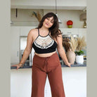 Leto Accessories lace high neck top women in black with intricate detailing, styled with brown pants