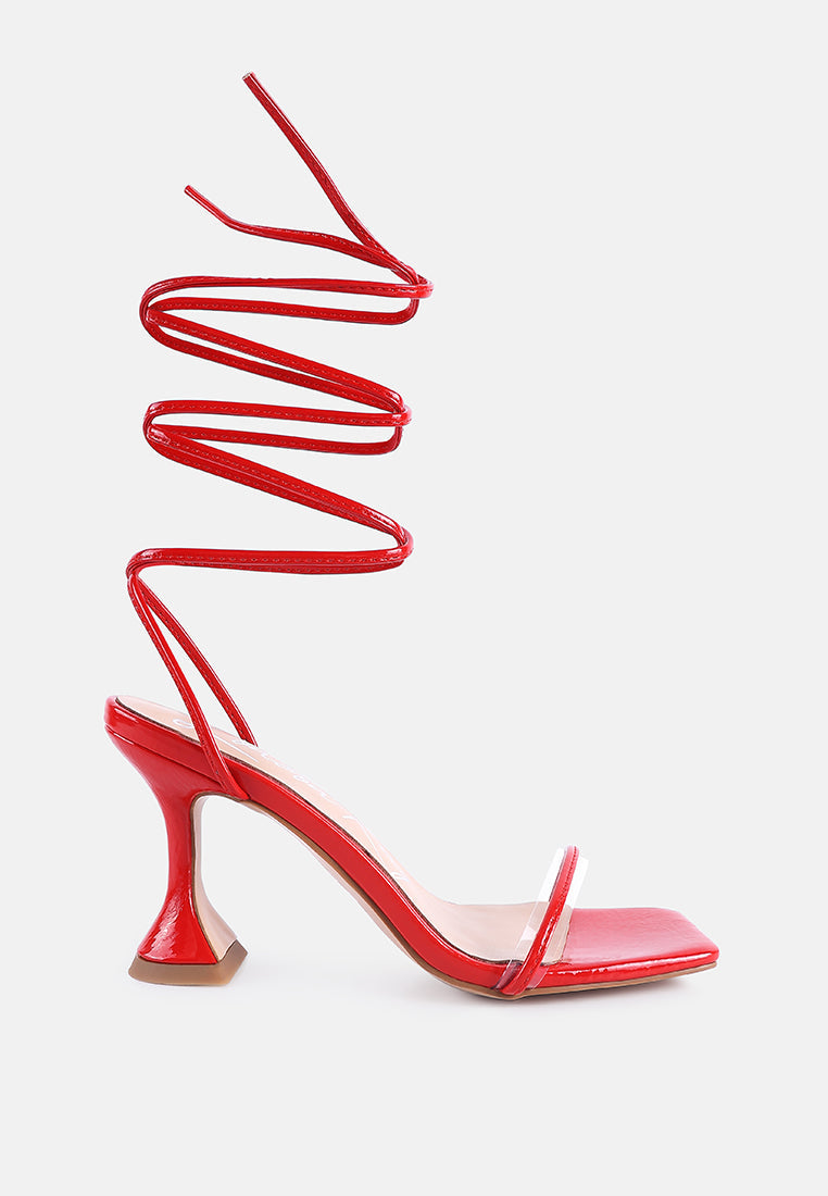 Stylish lace up spool heel sandals in vibrant red with a unique twisting strap design