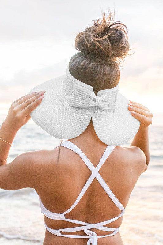 Stylish large brim bow beach hat in white, perfect for sunny days and beach outings.
