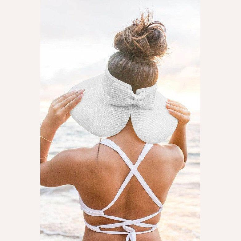 Stylish large brim bow beach hat in white, perfect for sunny days and beach outings.