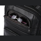 Large leather travel backpack featuring a front pocket for easy access to sunglasses