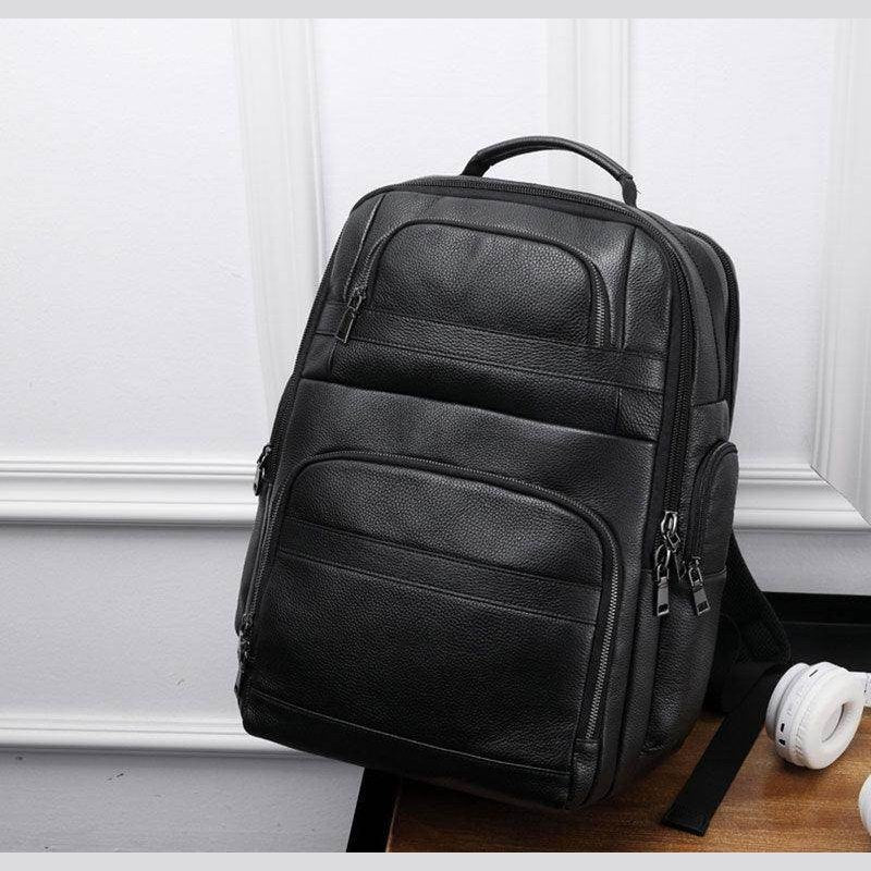 Large leather travel backpack with multiple compartments and a sleek design for convenient travel