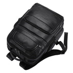 Large leather travel backpack with multiple compartments and padded shoulder straps for comfort