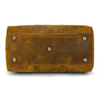 Bottom view of a large leather weekend bag with metal feet for stability and durability