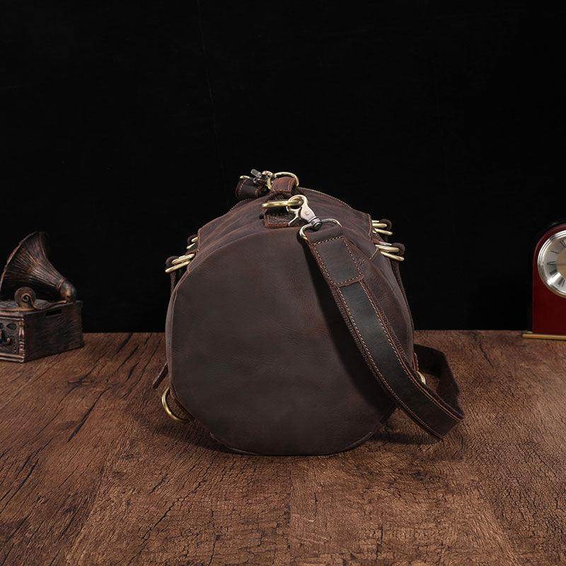 Large travel bag for men made of durable leather, featuring sturdy handles and adjustable shoulder strap