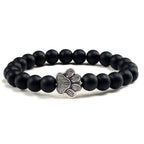 Lava stone pet bracelet with black matte beads and a silver paw print charm for pet lovers