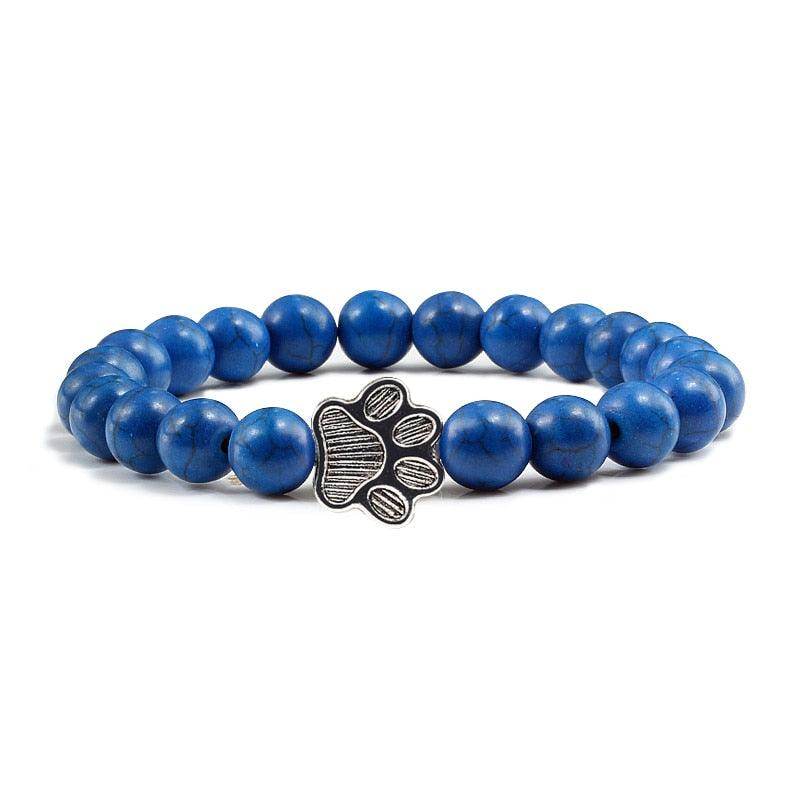 Lava stone pet bracelet featuring a blue design and a silver paw print charm for pet lovers