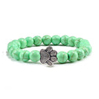 Lava stone pet bracelet with green beads and a silver paw charm, perfect for pet lovers