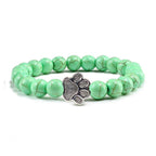 VacationGrabs lava stone pet bracelet featuring green beads with a silver paw print charm