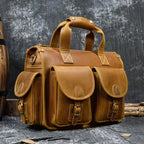 Tan leather bag for laptop with multiple pockets and sturdy handles
