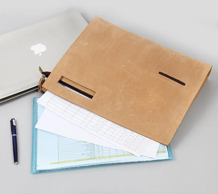 Tan leather briefcase with documents and a laptop, ideal for professionals