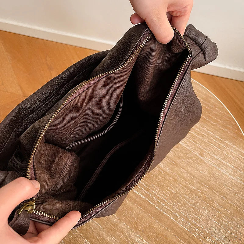 Brown leather crossbody mini bag with spacious interior for essentials