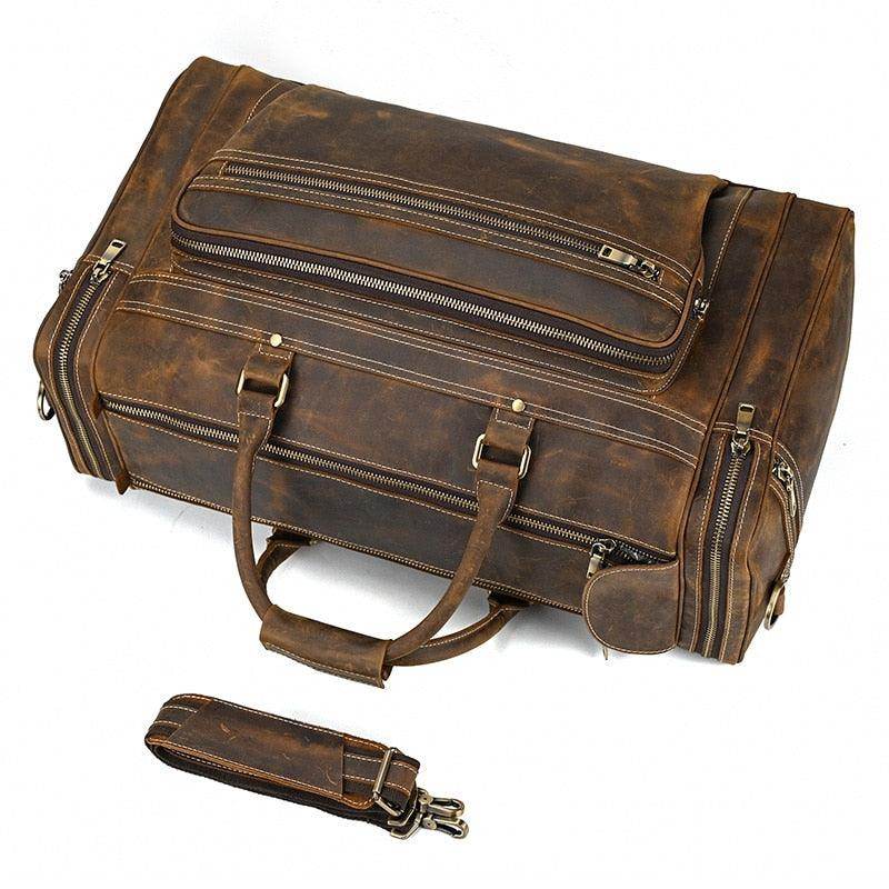 Brown leather luggage tote bag with multiple compartments and sturdy handles for travel convenience
