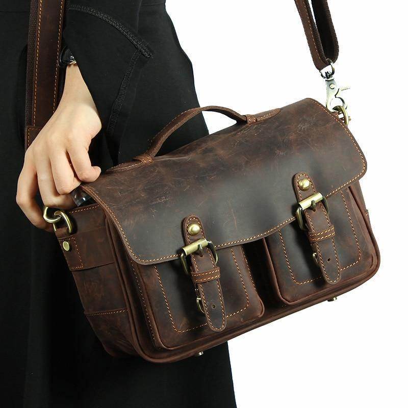 Brown leather messenger bag for photography with adjustable strap and multiple pockets