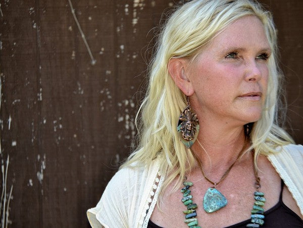 Elegant leather necklace with turquoise pendant worn by a woman, showcasing its unique design and natural beauty