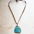 Leather necklace with turquoise pendant featuring a unique shape and earthy tones for a stylish look