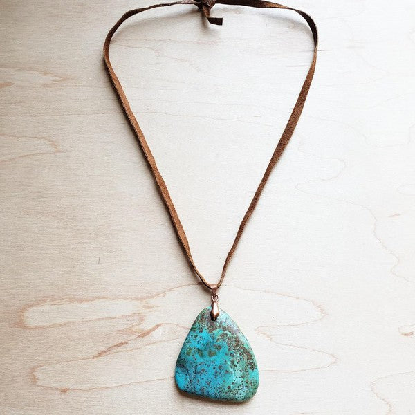 Leather necklace with turquoise pendant featuring a unique shape and earthy tones for a stylish look