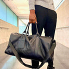 Stylish leather overnight duffel bag being carried for travel convenience and elegance