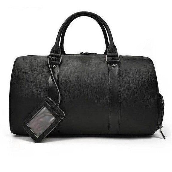 Elegant leather overnight duffel bag in black with durable handles and a luggage tag