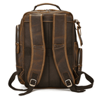 Leather style travel backpack with padded straps and multiple compartments for convenience and comfort