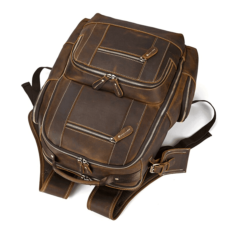 Leather style travel backpack from VacationGrabs featuring multiple zippered pockets and durable straps