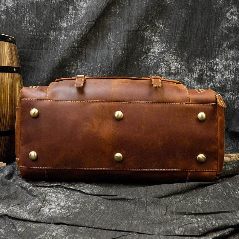 Durable leather weekend bag with shoulder strap featuring a stylish design and sturdy base for stability