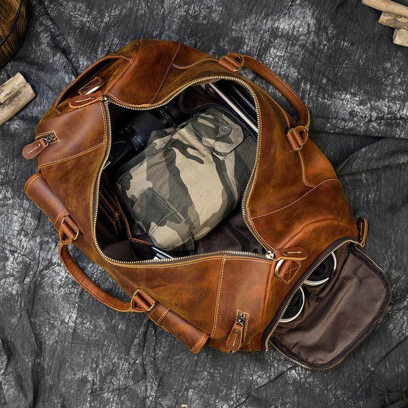 Leather weekend bag with shoulder strap featuring a spacious interior for easy packing and travel comfort