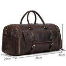Brown leather weekend bag with shoulder strap, featuring multiple pockets and sturdy handles
