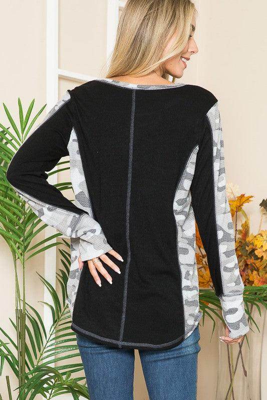 Back view of women's shirt featuring leopard print thumbhole knit design in black and gray