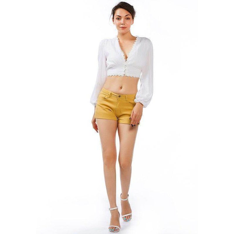 Stylish women's light blue summer shorts paired with a white cropped top for a trendy look