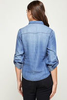 Back view of Blue Age lightweight denim shirt for travel on woman with rolled sleeves