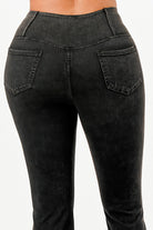 Back view of lightweight flare jeans for women featuring a sleek black design and two pockets