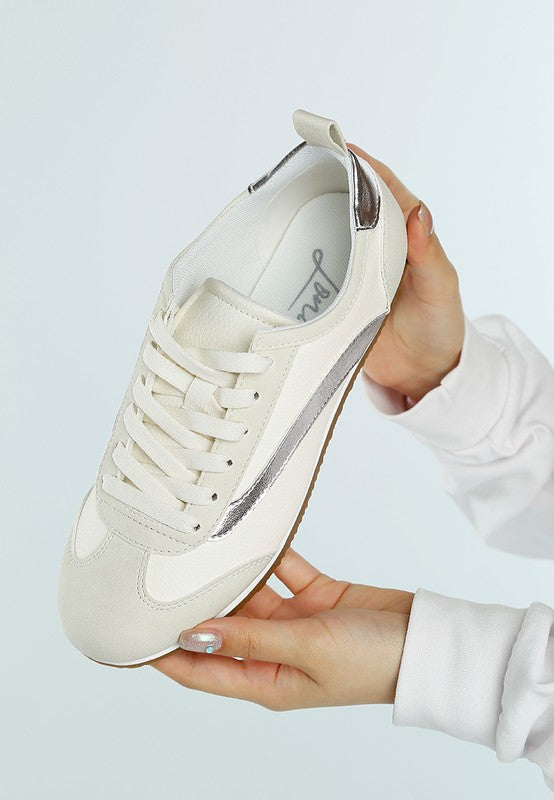 Rag Company lightweight stylish lace up sneakers in white with silver accents held in hands