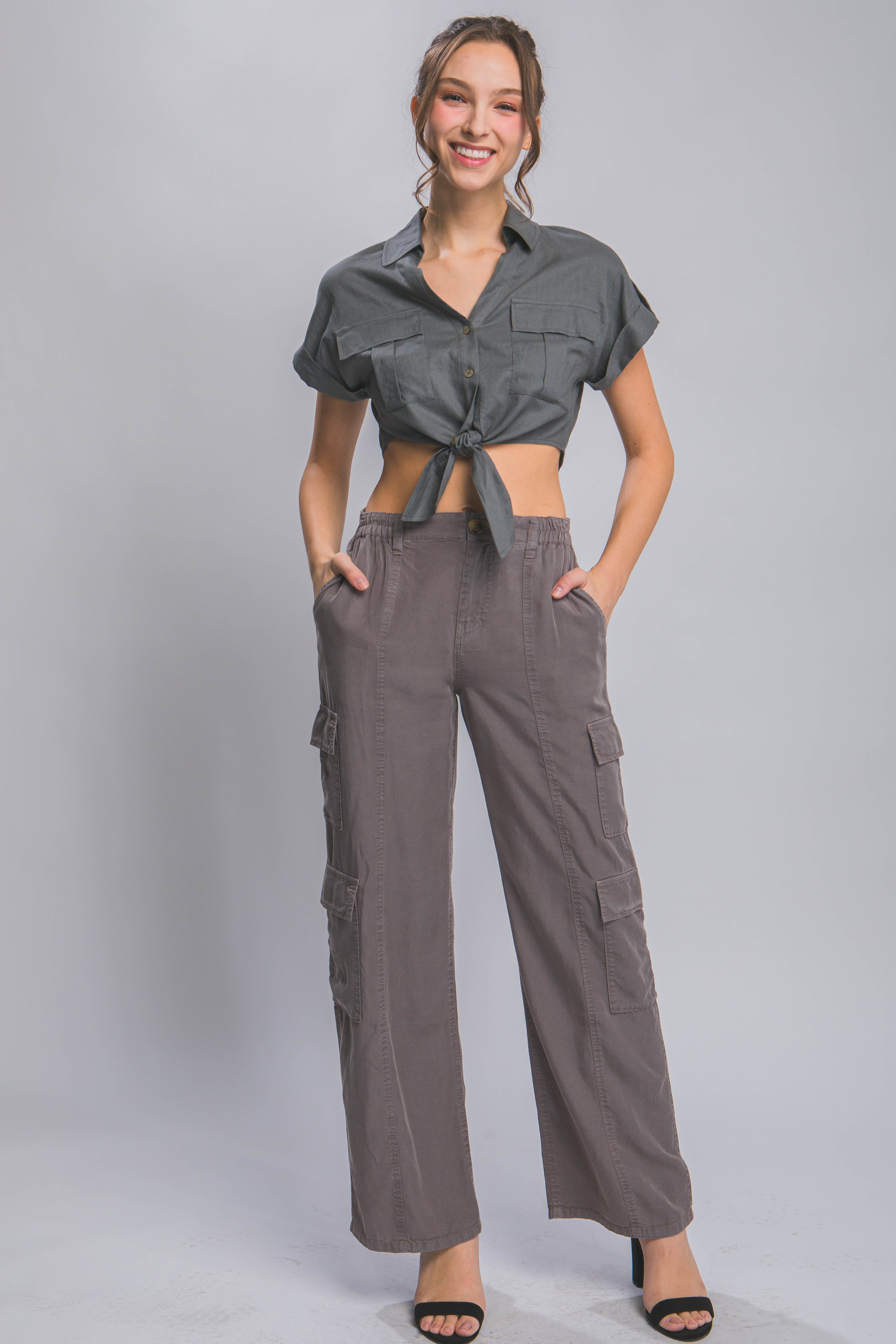 Women wearing lightweight travel pants with pockets in gray cargo style by VacationGrabs