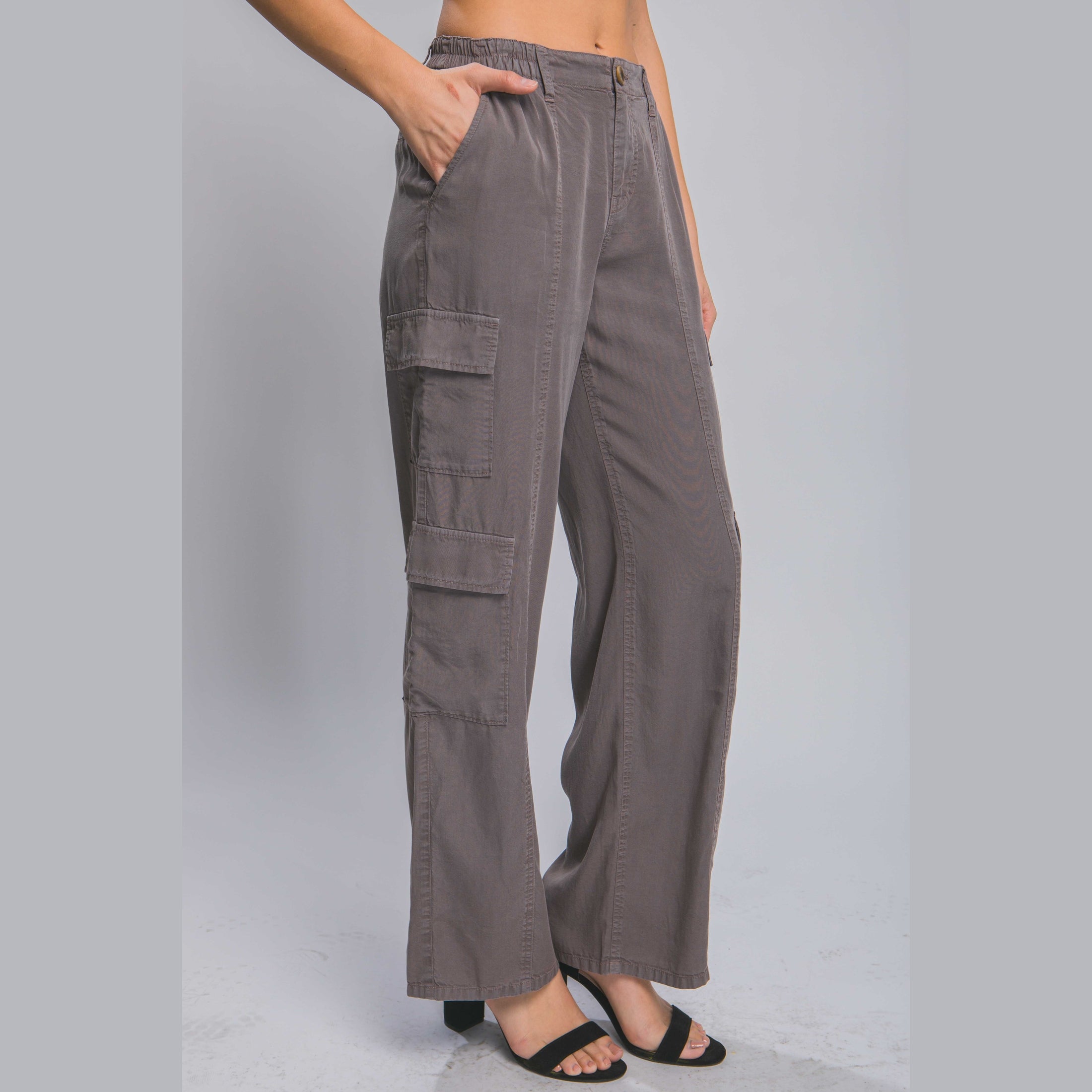 Women's lightweight travel pants with pockets in gray by VacationGrabs styled with black heels