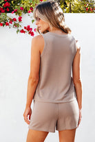 Lightweight womens loungewear set in beige ribbed fabric worn by woman outdoors with floral background