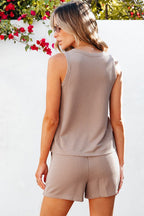 Lightweight womens loungewear set in beige ribbed fabric worn by woman outdoors with floral background