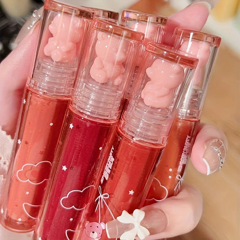 Set of five lip gloss tubes with bear-shaped caps, vibrant colors