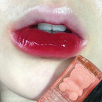 Red lip gloss with cute bear-shaped container for a glossy finish