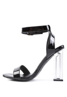 Chunky clear high heeled sandals in black for stylish women's outfits