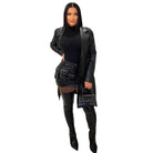 Stylish long leather coat for men worn over a black outfit for a chic look